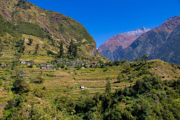 Trekking in the Himalaya mountains of Nepal with beautiful green hills, river and waterfalls