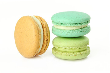 Three different colour macaroons isolated on white background. French delicacy cream cookies