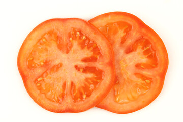 Two slices of tomato isolated on white background