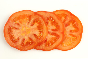 Three tomato slices isolated on white background