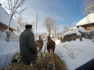 Sleighs pulled by horses ride through the snow. winter fairy tale