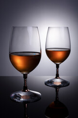 glasses with cognac on grey background