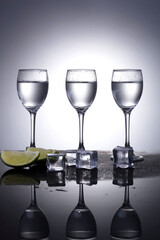 vodka with lime on grey background