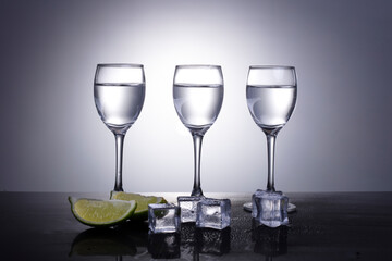 vodka with lime on grey background