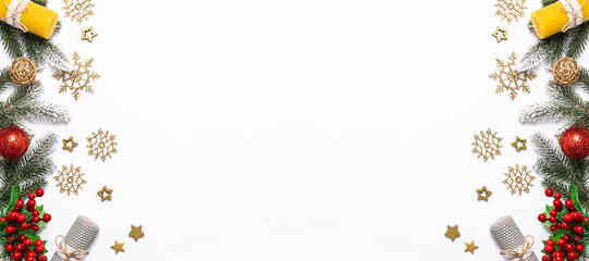 Long wide Christmas banner with fir tree branches and traditional Christmas decorations on white background with copy space for your design.