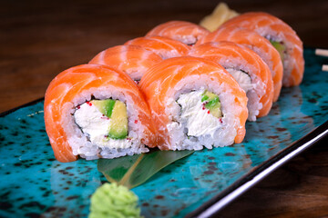 Sushi set with red fish on the table on blue dishes