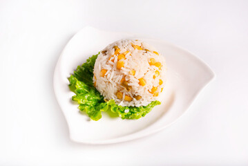 boiled rice with corn on a lettuce leaf. on a white background