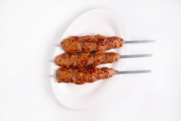 minced meat kebab on a white background