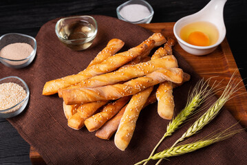 wheat flour bread sticks on a dark background