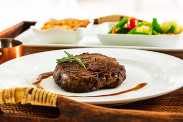 beef steak,Modern style barbecue dry aged sliced roast beef with fried onion rings and mashed potatoes as closeup on a plate