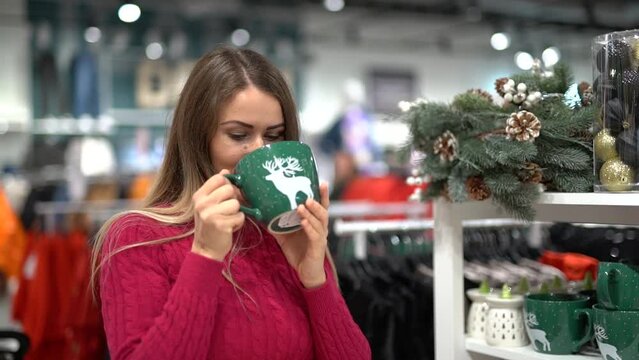 the girl likes a big green mug with a painted white deer. In the gift shop