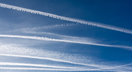 Cirrocumulus clouds that form in the sky from condensation trails left by aircraft - obrazy, fototapety, plakaty