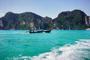 Naklejka na ściany i meble Vacation in Thailand, Phi Phi Island. Beautiful landscape with sea, boat and rocks.