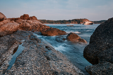 Fototapeta na wymiar Landscape with sea shore, waves and stones on the rocks beach.