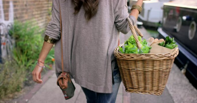 Woman, vegetables basket or city street walking with grocery shopping product, supermarket green leaf or healthy food produce. Retail customer, lettuce salad ingredients or carrier container on road