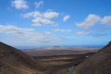 Red colored mountain landscape, blue sky with clouds