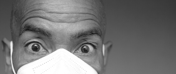 man with face masks fighting the coronavirus on grey background with people stock photo