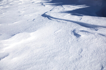 Fototapeta na wymiar white snowdrifts in cold and sunny winter day.close up