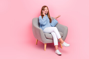 Fototapeta na wymiar Full body photo of cute concentrated speak talk phone conversation look empty space good proposition sit chair isolated on pink color background