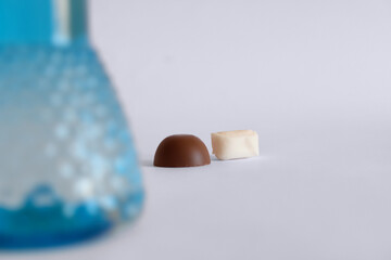 Chocolate and candy behind blurred cologne bottle. Happy Ramadan, happy kurban.(Turkish translate: Bayraminiz kutlu olsun. Kolonya şişesi, &ccedil;ikolata ve şeker. Ramazan bayrami ve kurban bayrami.)