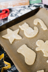 Freshly cut sugar cookies laying out on a cookie sheet ready to bake 