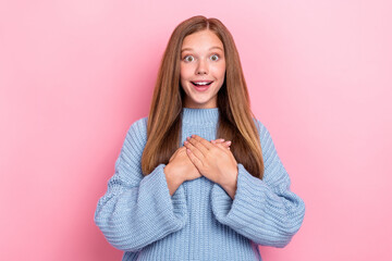 Photo of funny excited positive teenager schoolgirl wear blue knitted sweater hands chest thankful...