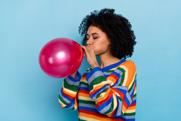 Profile photo of short hairdo lady blow balloon wear colorful pullover isolated on blue color...