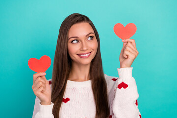 Portrait of gorgeous nice girl toothy smile look arms hold little heart cards isolated on cyan...