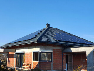House under construction with solar panels on the roof