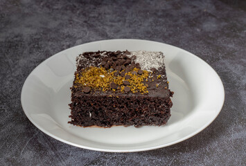Chocolate moist cake in a white plate , brownie .