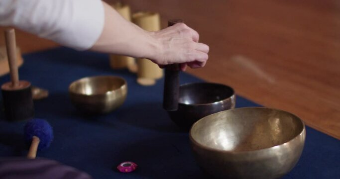 woman playing suzu rin singing bowl