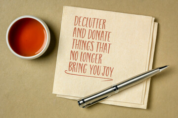 declutter and donate thing that no longer bring you joy - inspirational note on a napkin with a cup...