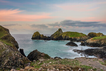 Beautiful dawn landscape over Kynance Cove in Cornwall England with vibrant sky and beautiful turquoise ocean