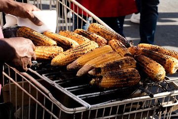 Grilled corn on the cob for sale at the exit of the metro and in front of the major French...