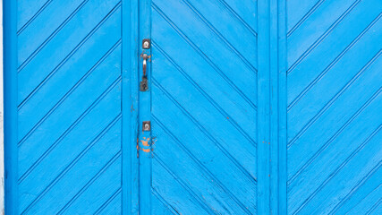 Puerta rústica de tablones de madera pintadas de azul vibrante