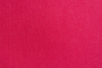 Close-up texture of natural scarlet or pink fabric. Cloth as background. Bright material for design