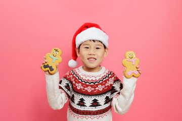 Merry Christmas! Young girl celebrating Christmas against pink background