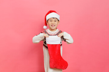 Merry Christmas! Young girl celebrating Christmas against pink background