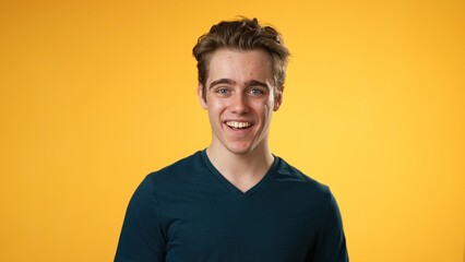 Portrait of smiling happy young hipster man 20s isolated on solid yellow background with copy space in studio