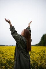 Cheerful girl in the field in summer