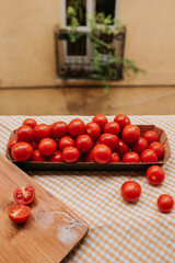 Fresh ripe red cherry tomatoes in a bowl on the table. Healthy food, organic vegetables. Natural vitamins, food raw materials. Handpicked bio tomato
