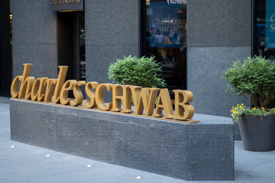 New York, NY, USA - July 2, 2022: Charles Schwab logo is seen outside one of its branches in New York City. The Charles Schwab Corporation is an American global financial services company.