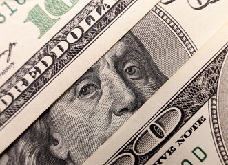 Benjamin Franklin's eyes close-up on the US 100 dollar bill. American currency concept, dollar exchange rate