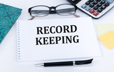RECORD KEEPING text written on paper folder and charts