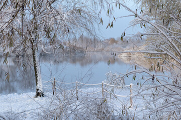 Snowy landscape with a river on a frosty day. Magic wintertime landscape.