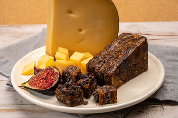 Cheese collection, old Dutch cheese with holes, made in the Netherlands served with fresh figs, figs bread with chocolate
