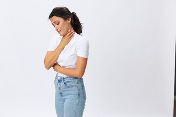 Woman pain throat and back, colds, cold and flu disease, covid-19, in a white t-shirt on a white background