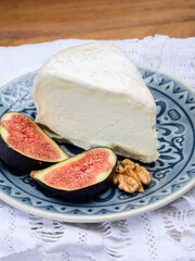 Delice de Bourgogne French cow's milk cheese from Burgundy region of France served with fresh figs and walnuts