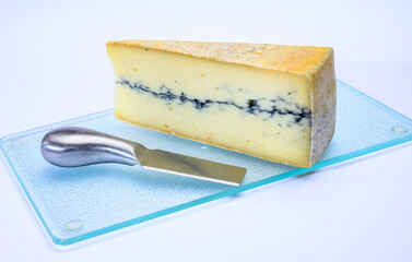 French semi-soft cow milk cheese morbier from Franche-Comte region with thin black layer and strong aroma