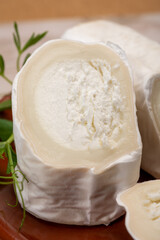 French organic matured white goat cheese with white rind close up served with fresh raspberries and figs